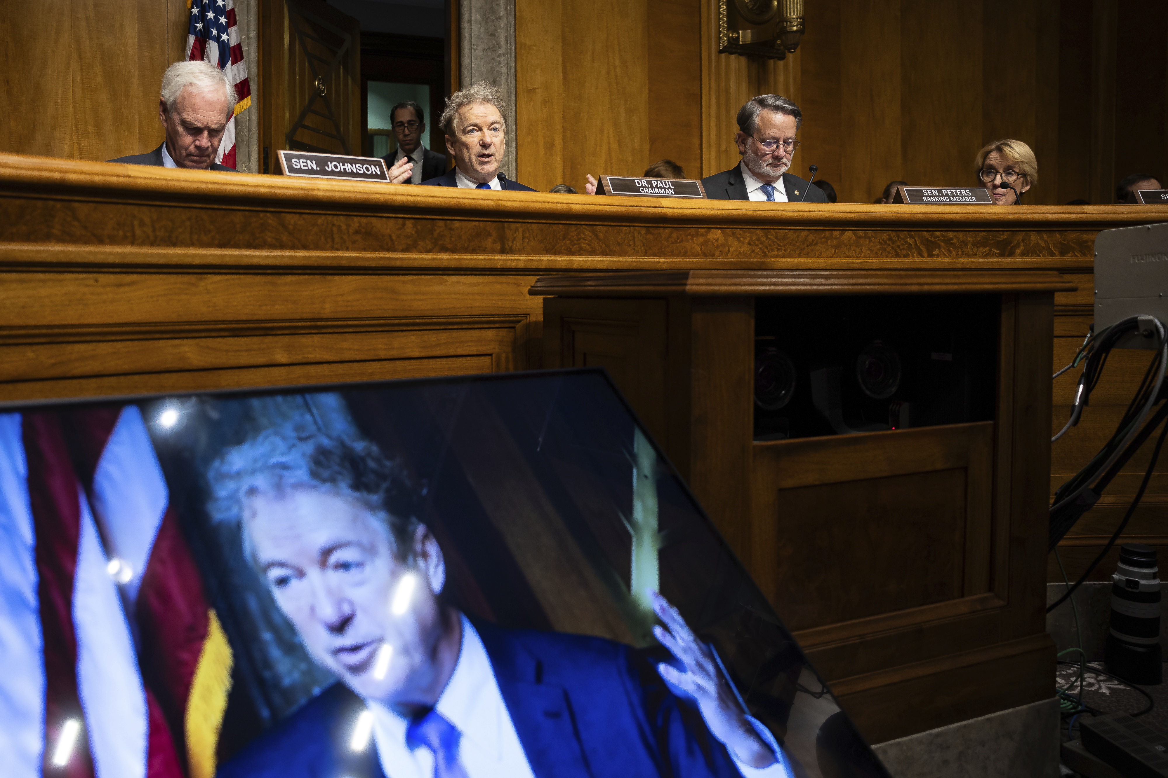 From left, Sens. Ron Johnson (R-Wis.), Rand Paul (R-Ky.), Gary Peters (D-Mich.) and Maggie Hassan (D-N.H.) are seen during Vought's confirmation hearing.