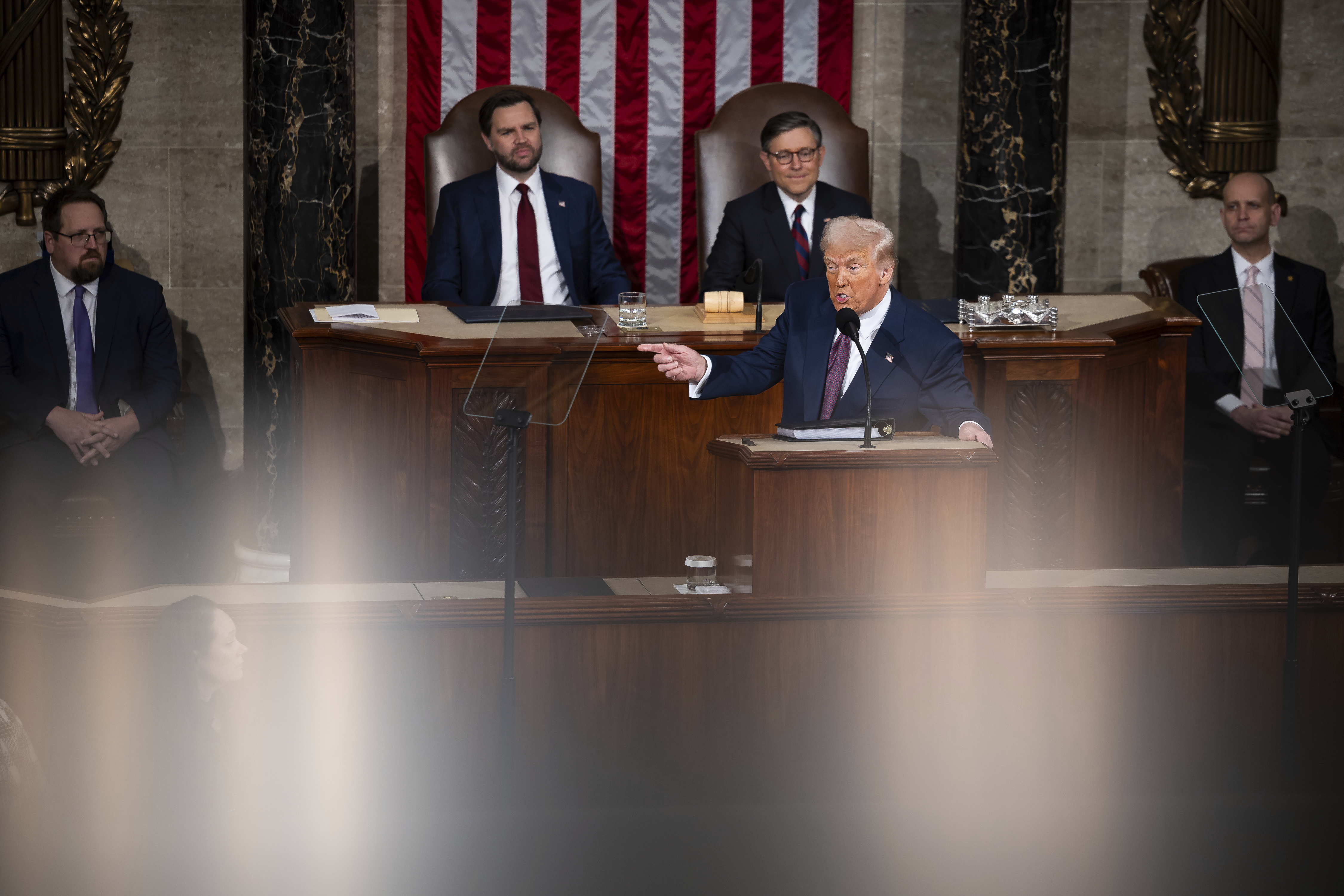 President Donald Trump delivers an address to a joint session of Congress in the House chamber of the U.S. Capitol in Washington, on March 4, 2025. Behind him, Vice President JD Vance and House Speaker Mike Johnson (R-La.) are seen.